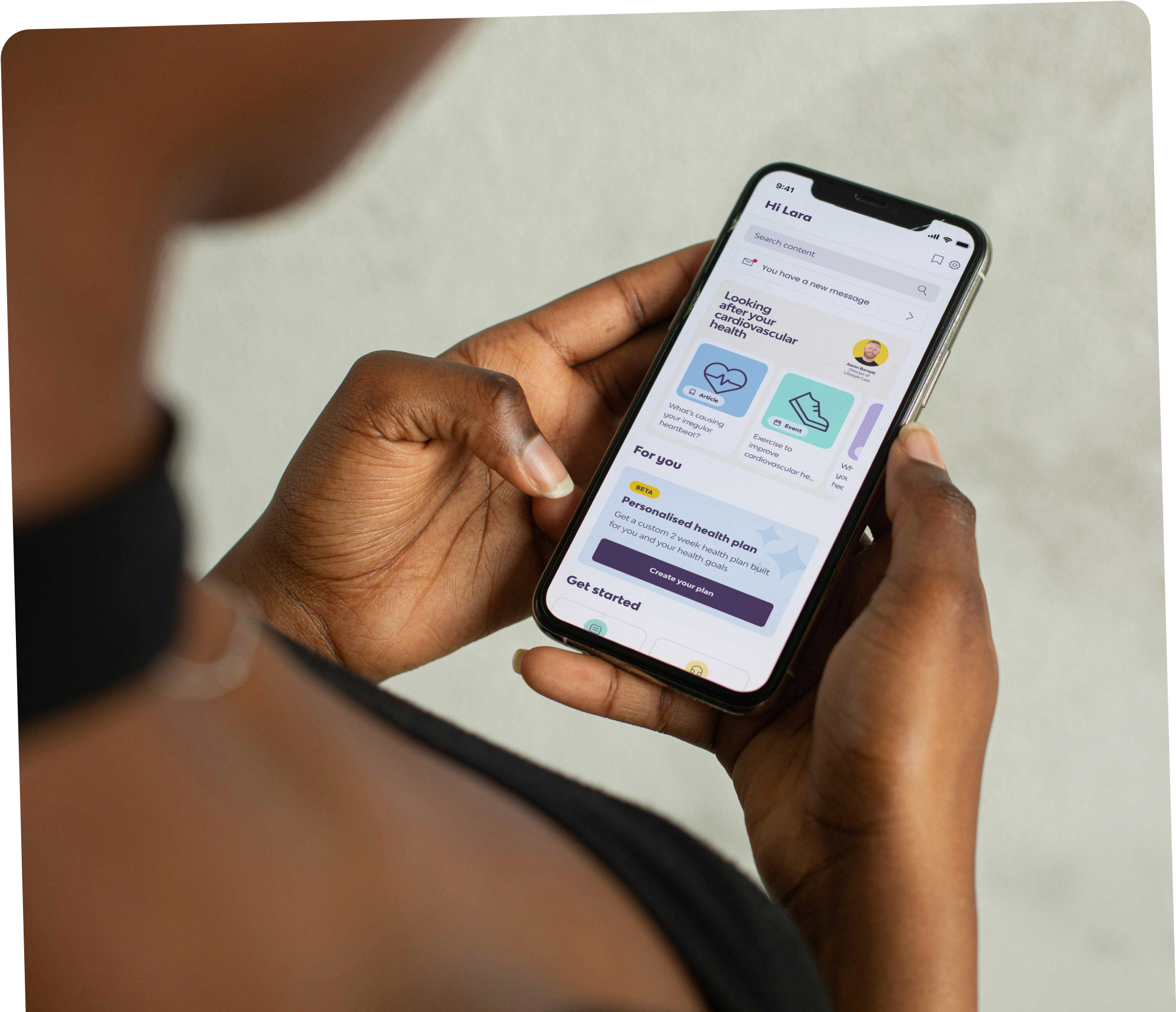 Close up of a person looking at a mobile phone screen, the screen has the welcome page of the peppy app Close up of a person looking at a mobile phone screen, the screen has the welcome page of the peppy app