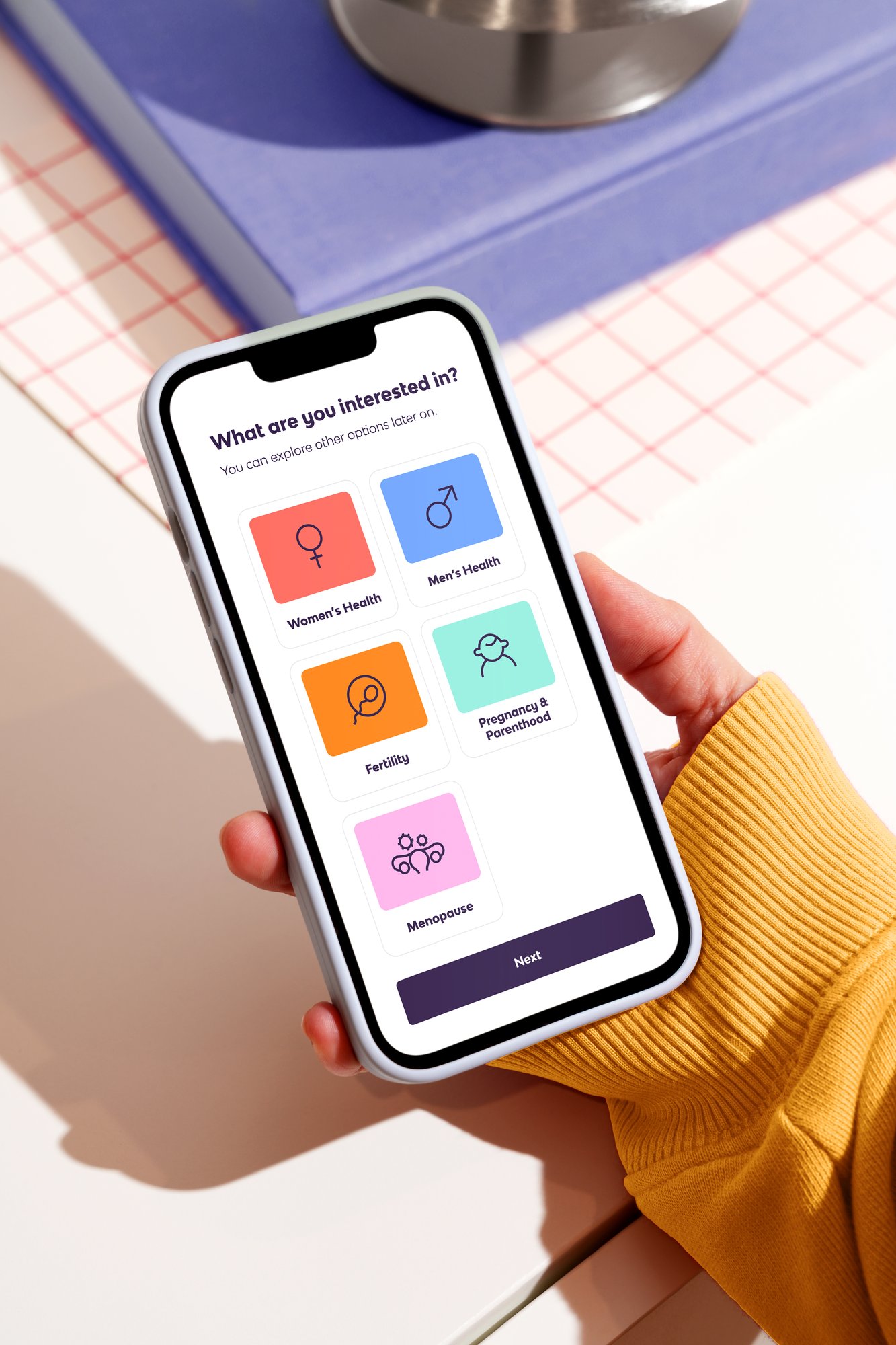 Peppy app sign up screen on a phone, showing the 5 verticals, Women's Health, Men's Health, Fertility, Pregnancy & Parenthood and Menopause under the header ' What are you interested in'.