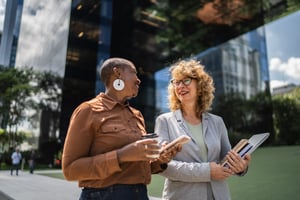 POC woman talking to her friend at work