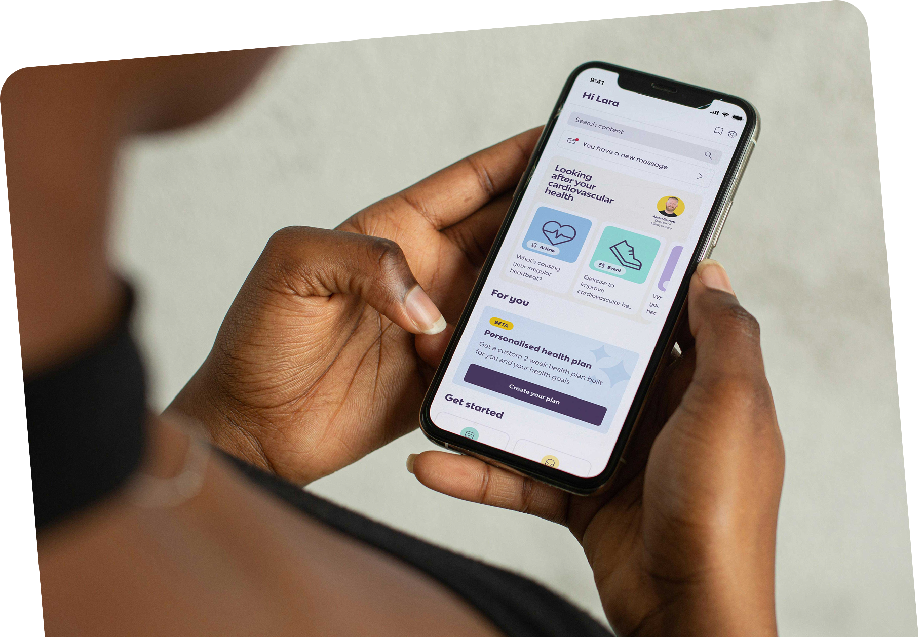 Person holding a phone showing the Peppy app welcome screen Person holding a phone showing the Peppy app welcome screen