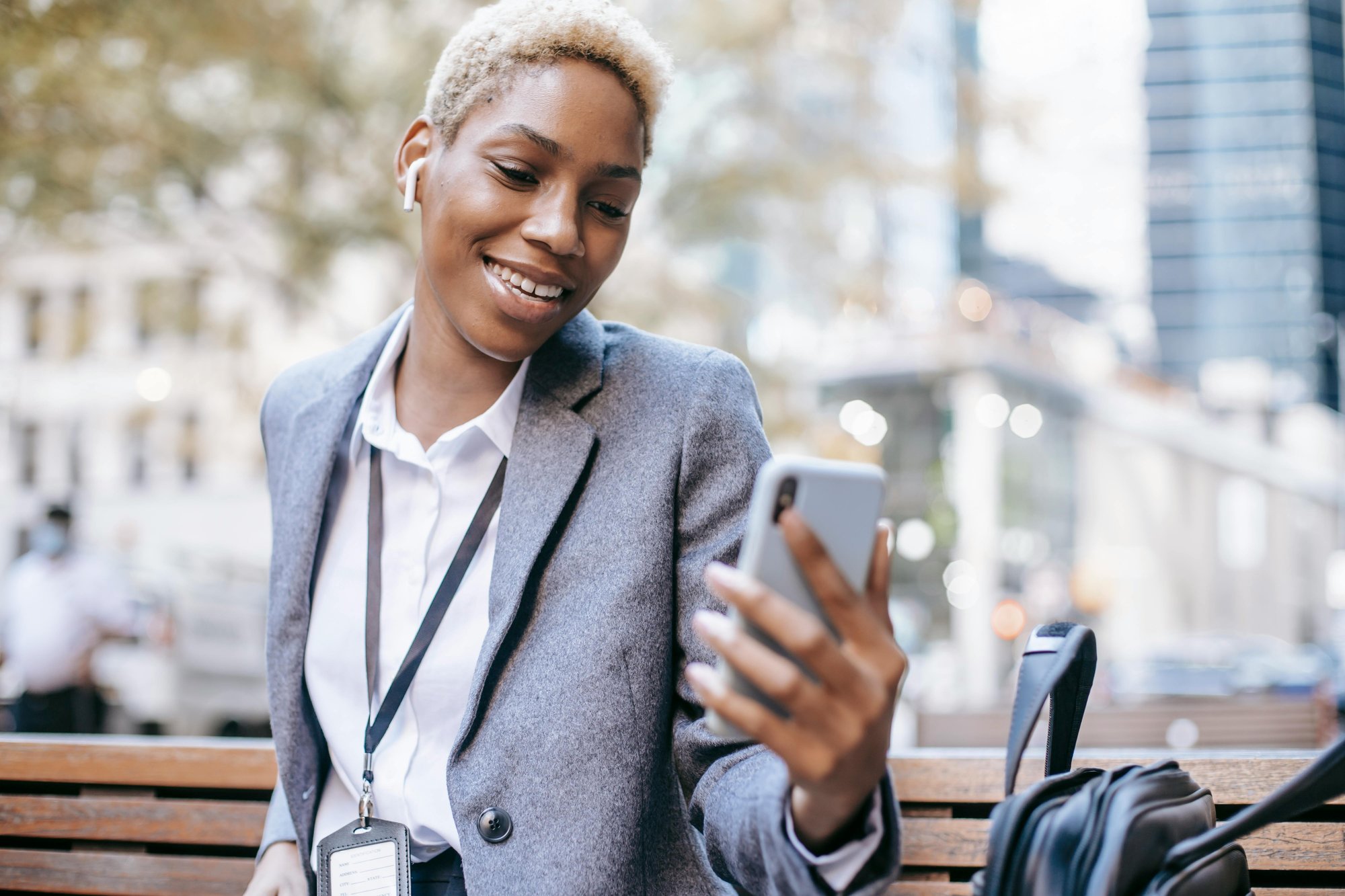 Smiling professional looking at their phone, illustrating specialist health support for employees