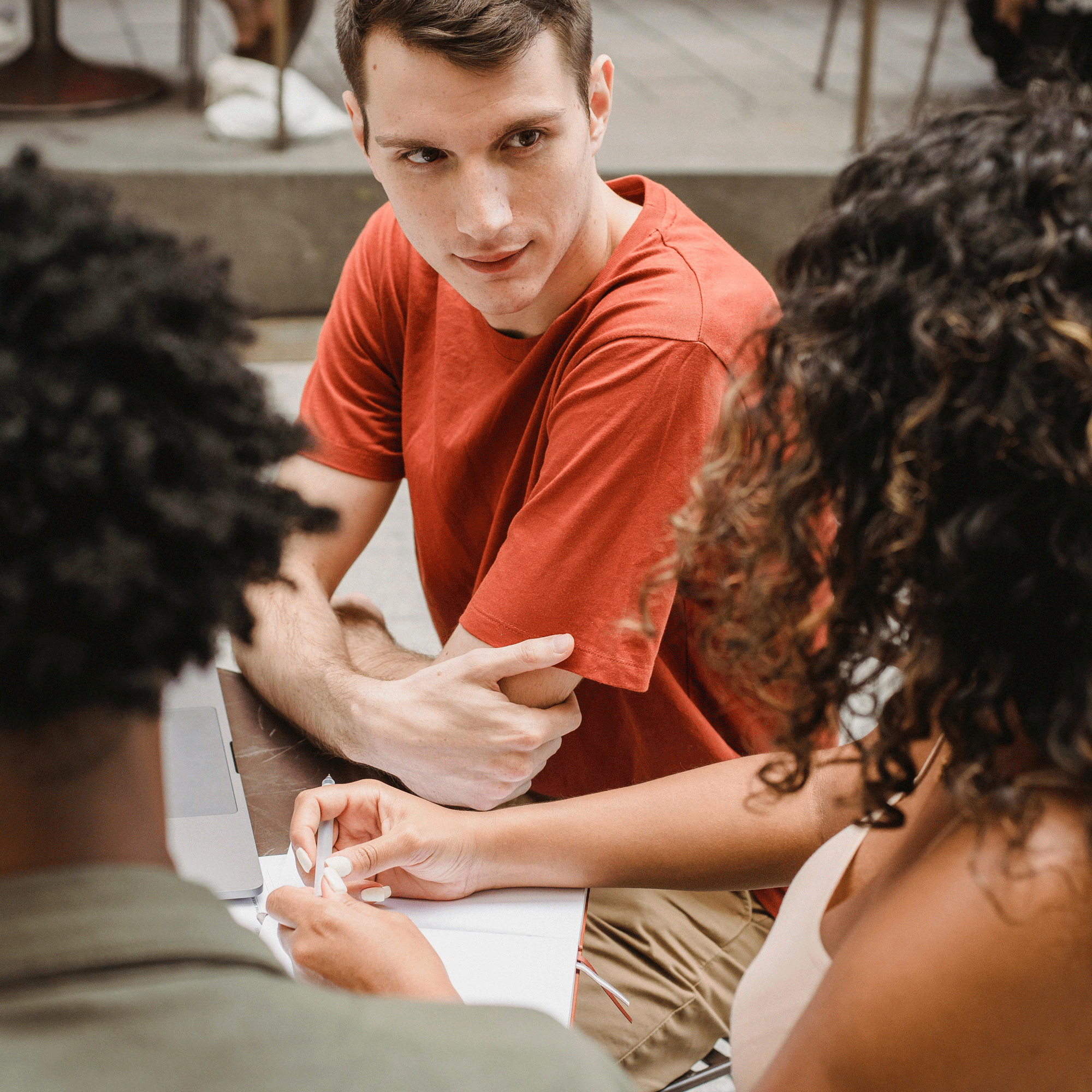 Colleagues working together in a modern office environment, focus on a young man